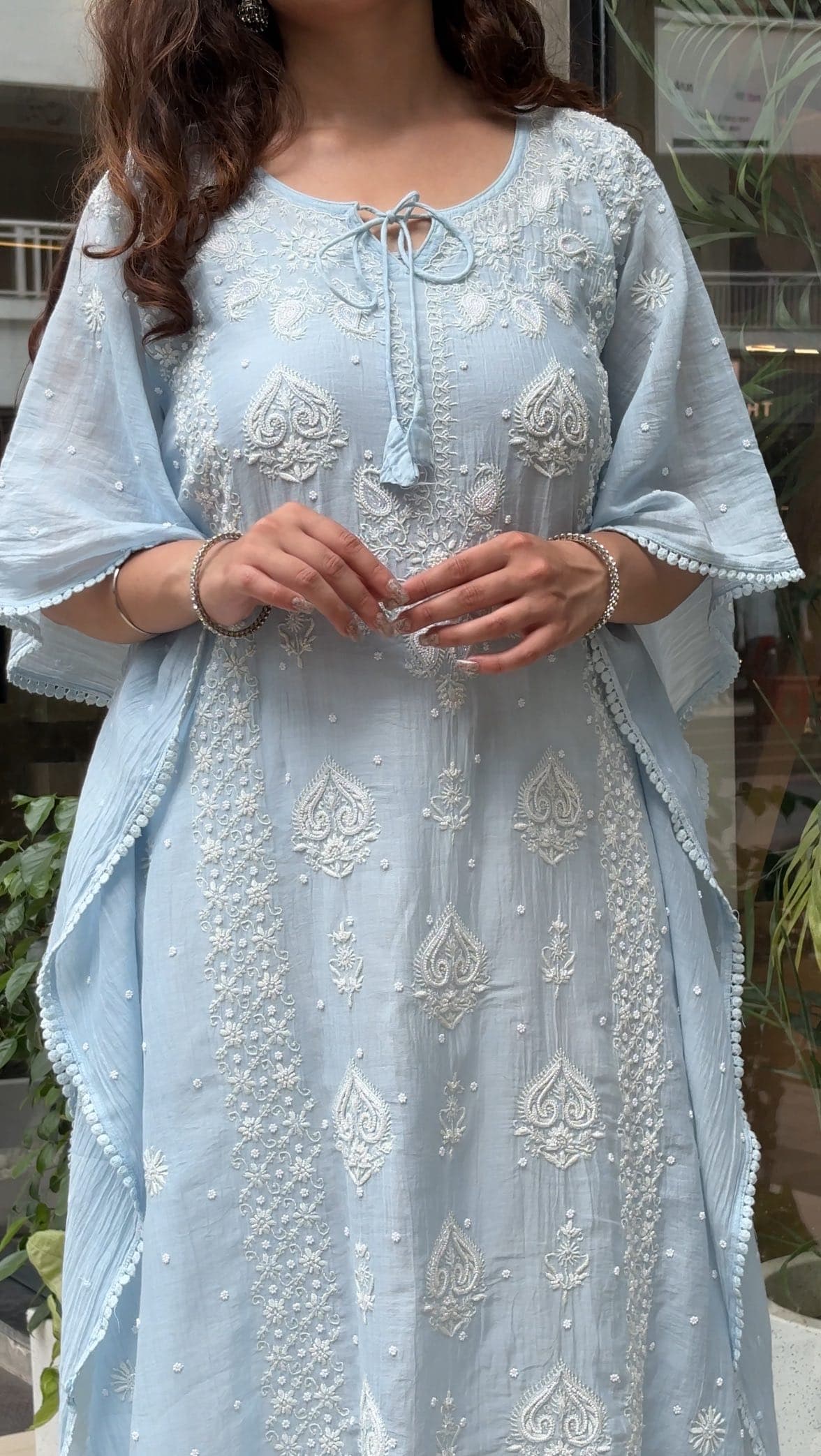 Crafted in the soft elegance of Mul Chanderi, this Ethnava kaftaan is adorned with intricate pearl and cutdan…